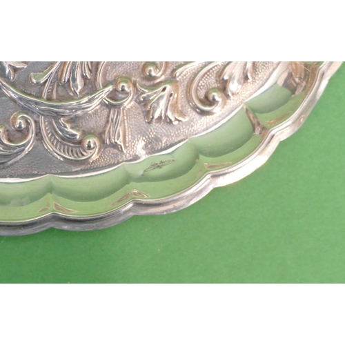 396 - A Continental Silver Coloured metal Oval Pin Dish having embossed bird, floral, leaf and scroll deco... 