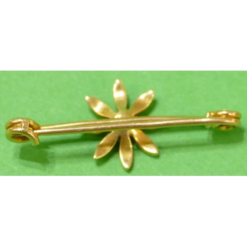 432 - A Gold Bar Brooch having centre floral motif inset with half pearls, 3.5cm wide, overall weight 2.7g... 