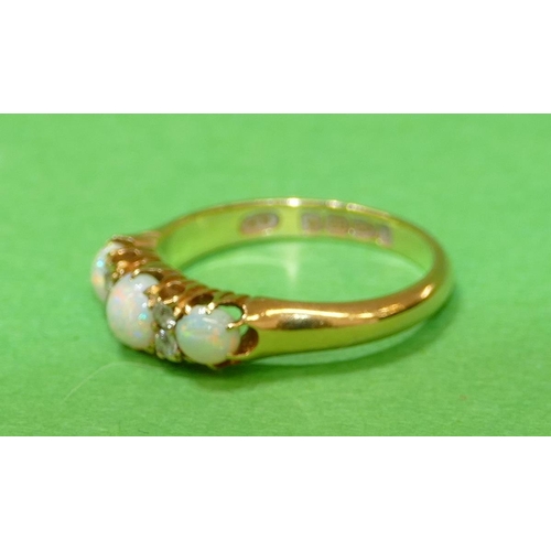 452 - An 18ct Gold Ladies Ring set with 3 centre opals, interspersed by 4 small diamonds, size N.