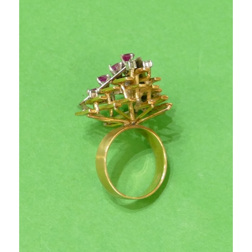 523 - An 18ct 2 Coloured Gold Ladies Cluster Ring having triangular motif, inset with 7 rubies intersperse... 