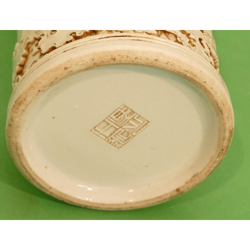 54 - An Oriental Cylindrical Brush Pot on white ground having raised Oriental figure, animal and tree dec... 