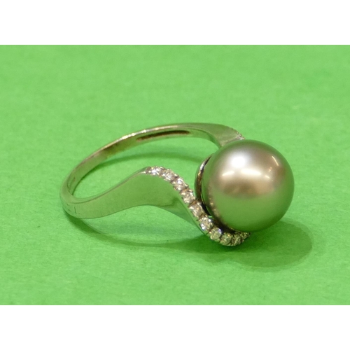 574 - A 9ct White Gold Ladies Ring set with silvered pearl surrounded by row of 19 small diamonds, size Q/... 