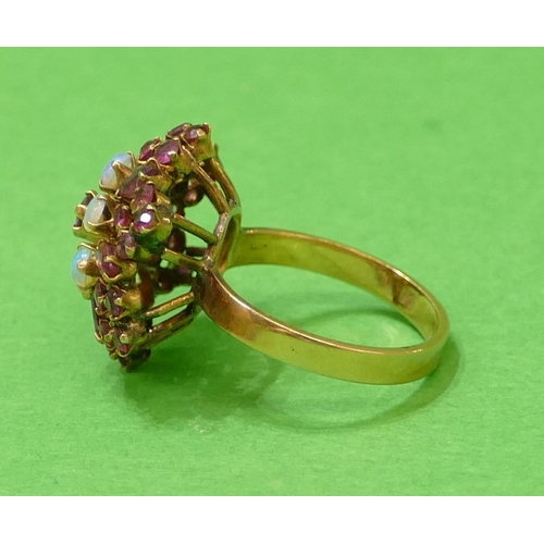 581 - An 18ct Gold Cluster Ring set with red stones and opals, size O, 4.7g.