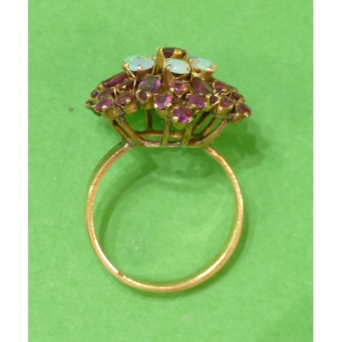 581 - An 18ct Gold Cluster Ring set with red stones and opals, size O, 4.7g.