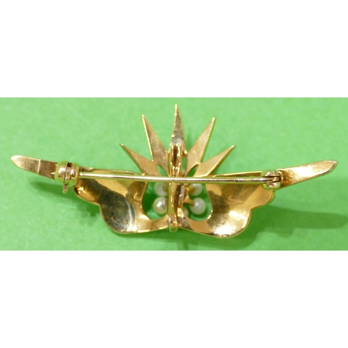 604 - A Gold Winged Shaped Brooch mounted with crown motif inset with all over half pearls, with centre di... 