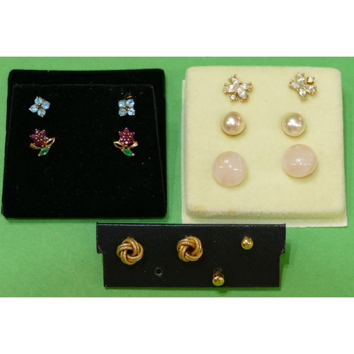 623 - A Pair of 9ct Gold Floral Earrings mounted with red and green stones, a pair of 9ct gold knot earrin... 