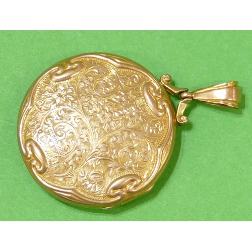 656 - A 9ct Gold Circular Locket having all over floral, leaf and scroll decoration, 4.8cm high overall, 7... 