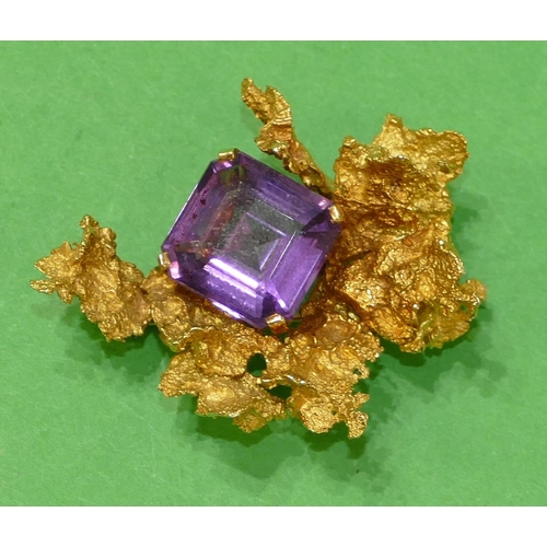 666 - An 18ct Gold Amethyst Brooch having all over raised leaf decoration, 5.3cm wide, 29.5g gross.