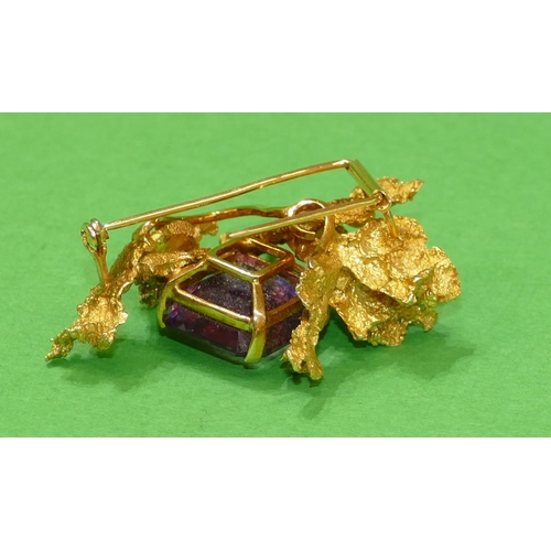 666 - An 18ct Gold Amethyst Brooch having all over raised leaf decoration, 5.3cm wide, 29.5g gross.