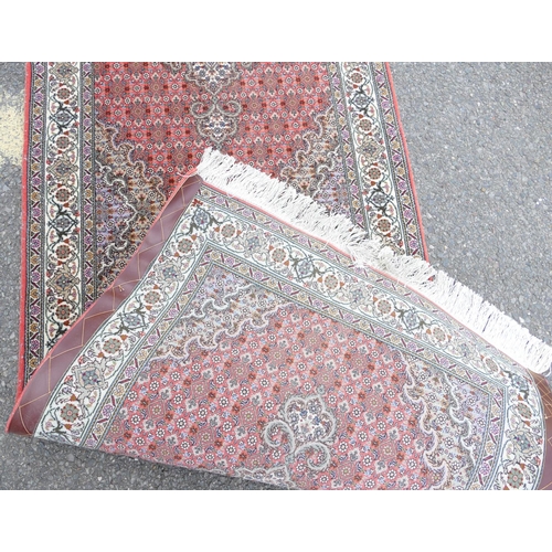 710 - A Persian Style Runner on red and cream ground having 3 centre medallions, 3m 5cm x 82cm.