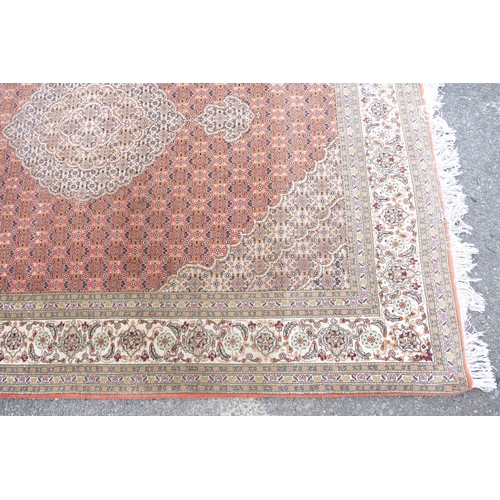 712 - A Persian Style Rug on cream ground having centre medallion, 1m 98cm x 1m 55cm.