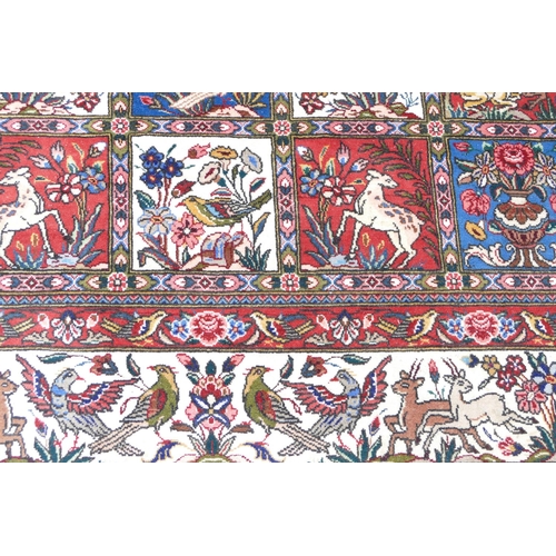 714 - A Wool Carpet on white, red and blue ground having all over bird decoration, 3m 15cm x 2m 6cm.