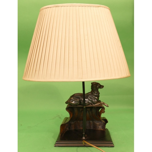 715 - A Good Quality Spelter Table Lamp in form of a relaxing dog on scallop shaped platform with shade an... 