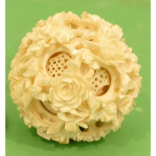 738 - An Early 20th Century Carved Ivory Puzzle Ball on stand having all over floral and leaf decoration, ... 