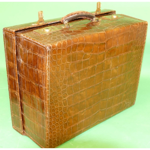 753 - A Crocodile Travelling Case with outer cover, hinge lid enclosing part fitted interior, 46.5cm wide.