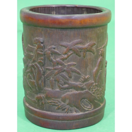 762 - A Bamboo Cylindrical Brush Pot having raised figure and landscape decoration, 16.5cm high.