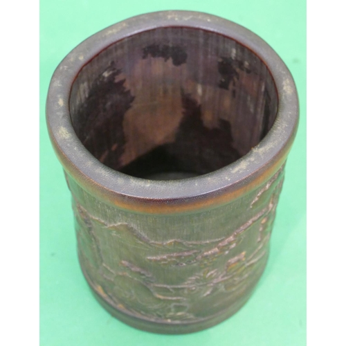 762 - A Bamboo Cylindrical Brush Pot having raised figure and landscape decoration, 16.5cm high.