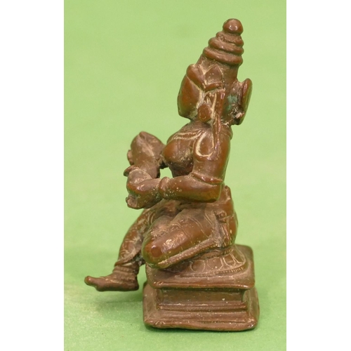 765 - A Small Bronze Eastern Figure of a seated lady, 7.5cm high.