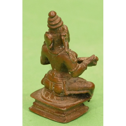 765 - A Small Bronze Eastern Figure of a seated lady, 7.5cm high.