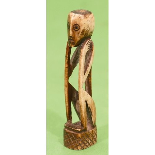 767 - A Carved Bone Candle Holder in form of a seated figure, 10.5cm high.