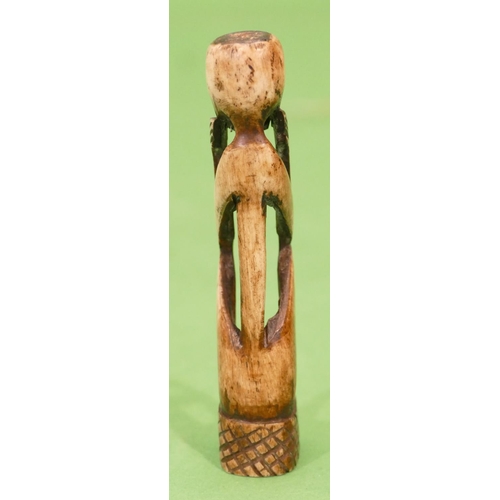 767 - A Carved Bone Candle Holder in form of a seated figure, 10.5cm high.