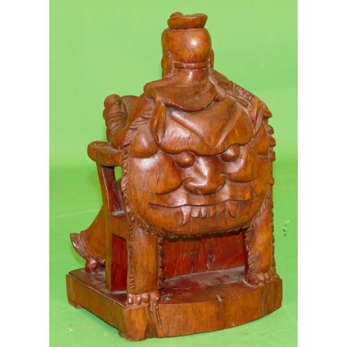 775 - A Carved Wooden Sculpture of an Oriental gentleman reading a scroll, 27.5cm high.