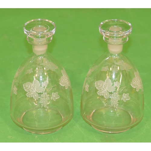 80 - A Pair of Glass Round Bulbous Thin Necked Decanters with stoppers having white grape and vine decora... 