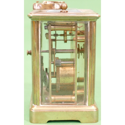 820 - A Brass Carriage Clock having swing overhead handle, cream enamelled dial with Arabic numerals, 12cm... 