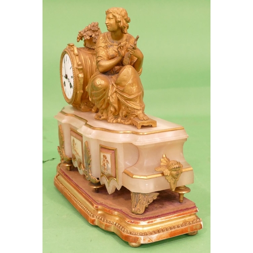 824 - J Marti, A 19th Century Gilt Metal and Onyx 8 Day Striking Drum Mantle Clock having a seated female ... 