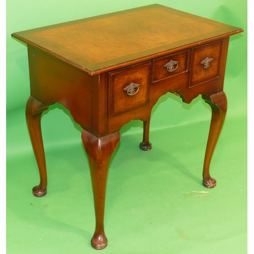 865 - A Reproduction Walnut Lowboy having banded herringbone top, centre drawer above knee hole flanked by... 