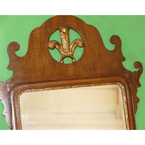 878 - A 19th Century Mahogany Wall Mirror with carved gilt Prince of Wales feathers motif, scallop shaped ... 