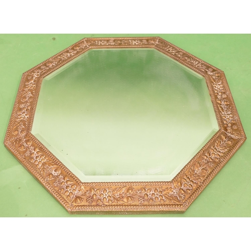 879 - An Octagonal Brass Hanging Bevelled Wall Mirror with embossed floral and leaf decoration, 47.5cm wid... 