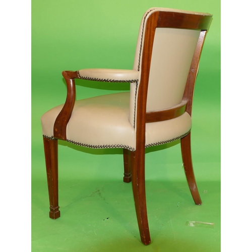 883 - A Reproduction Mahogany Armchair having overstuffed seat, back and padded arms, on square tapering l... 