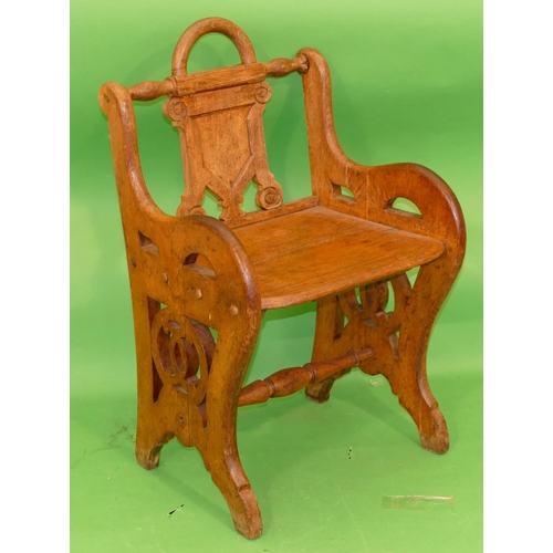 886 - A 19th Century Oak Hall Chair having shield back, solid seat on pierced splat end supports, centre t... 