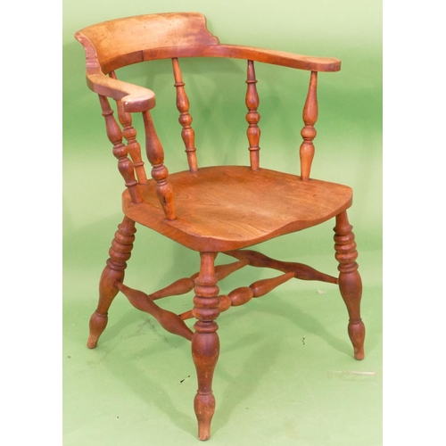 895 - An Elm Tub Chair having turned spindle back, solid seat on round turned legs.