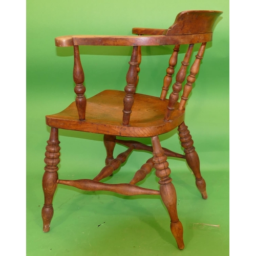 895 - An Elm Tub Chair having turned spindle back, solid seat on round turned legs.