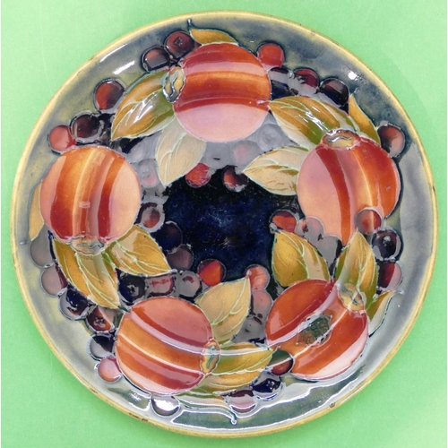 90 - An Early Moorcroft Side Plate having multicoloured pomegranate and leaf decoration, 16.8cm diameter.