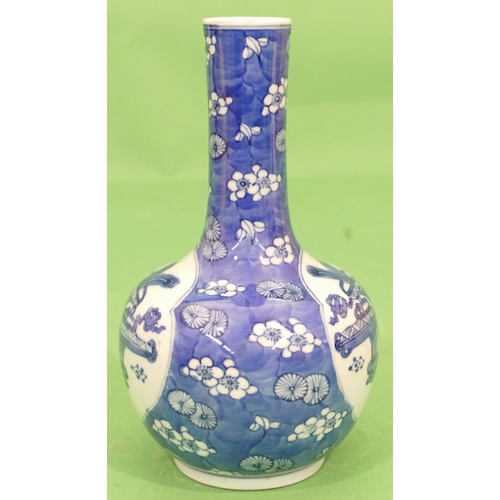 98 - An Oriental Round Bulbous Thin Necked Vase on blue and white ground having vase, floral and leaf dec... 