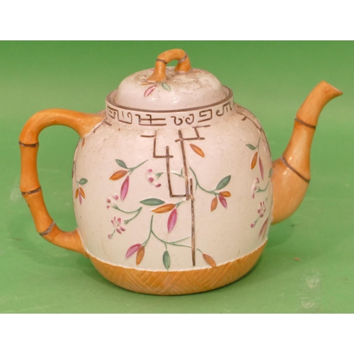 122 - A 19th Century Round Bulbous Shaped Teapot having bamboo shaped handle and spout on white and brown ... 