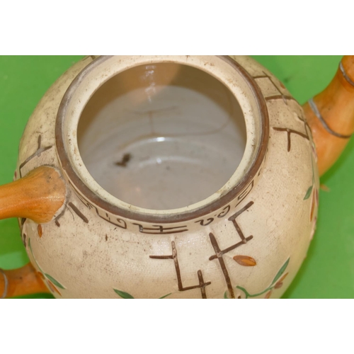 122 - A 19th Century Round Bulbous Shaped Teapot having bamboo shaped handle and spout on white and brown ... 