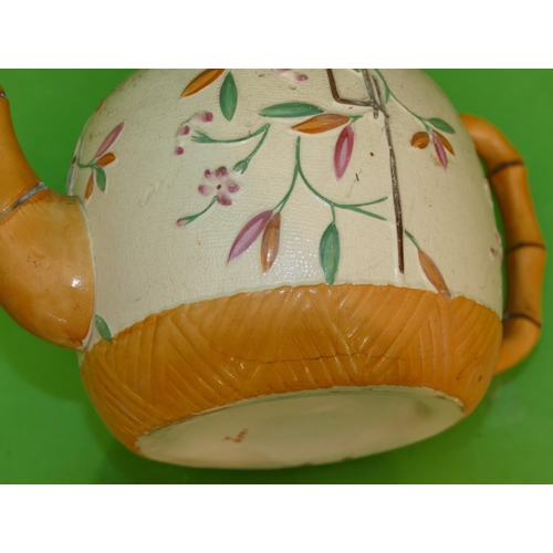 122 - A 19th Century Round Bulbous Shaped Teapot having bamboo shaped handle and spout on white and brown ... 