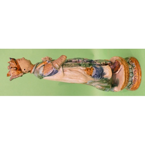 19 - An Oriental Glazed Earthenware Figure of a standing gentleman (both arms from elbows missing), on ov... 