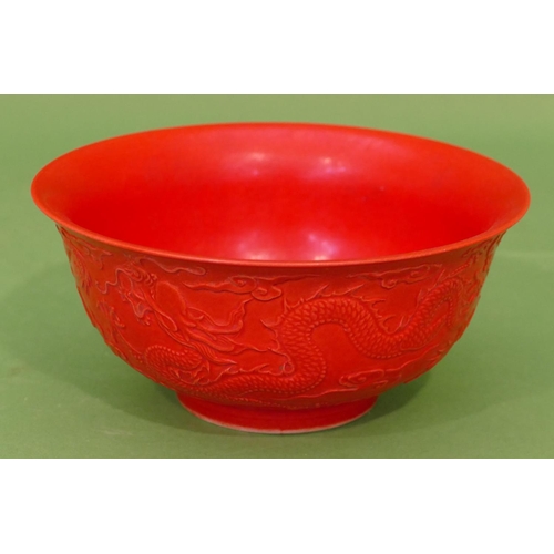 29 - An Oriental Red Round Trumpet Shaped Bowl having raised dragon decoration, 16cm diameter.