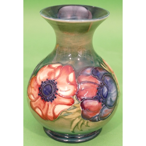 47 - A Moorcroft Round Bulbous Thin Necked Trumpet Shaped Vase on green and blue ground with multicoloure... 