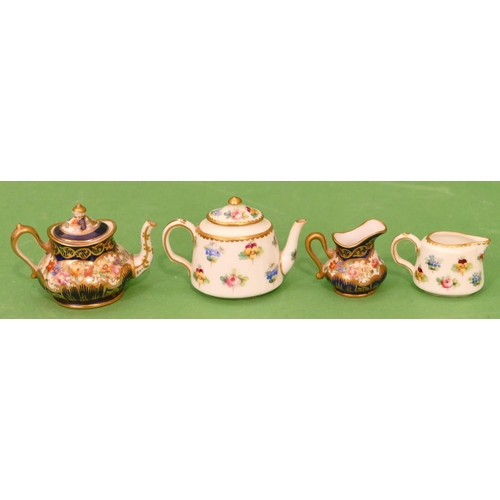 74 - A Minton Miniature Oval Teapot and matching cream jug on white ground with multicoloured floral leaf... 