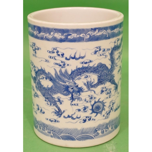 84 - An Oriental Cylindrical Brush Pot on blue and white ground having dragon and phoenix decoration, 16.... 