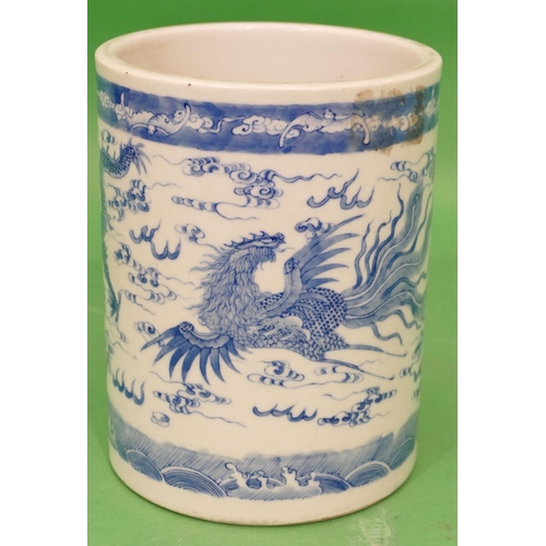 84 - An Oriental Cylindrical Brush Pot on blue and white ground having dragon and phoenix decoration, 16.... 