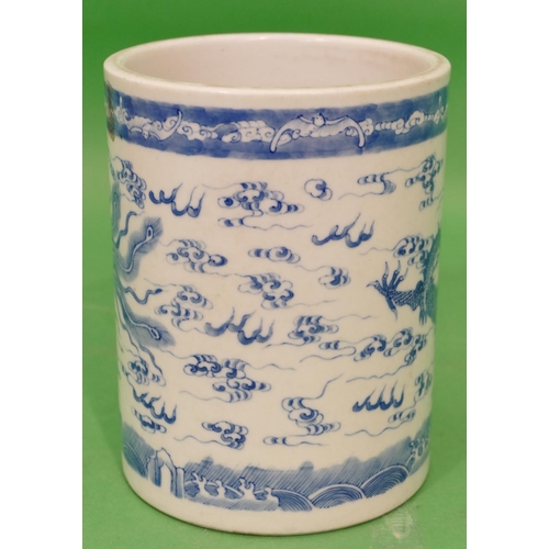 84 - An Oriental Cylindrical Brush Pot on blue and white ground having dragon and phoenix decoration, 16.... 