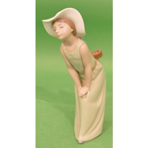 95 - A Lladro Figure of a young lady in green dress with white bonnet, 23cm high.