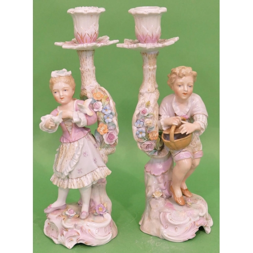 104 - A Pair of Continental China Figured Candlesticks in form of young gentleman and lady holding birds w... 